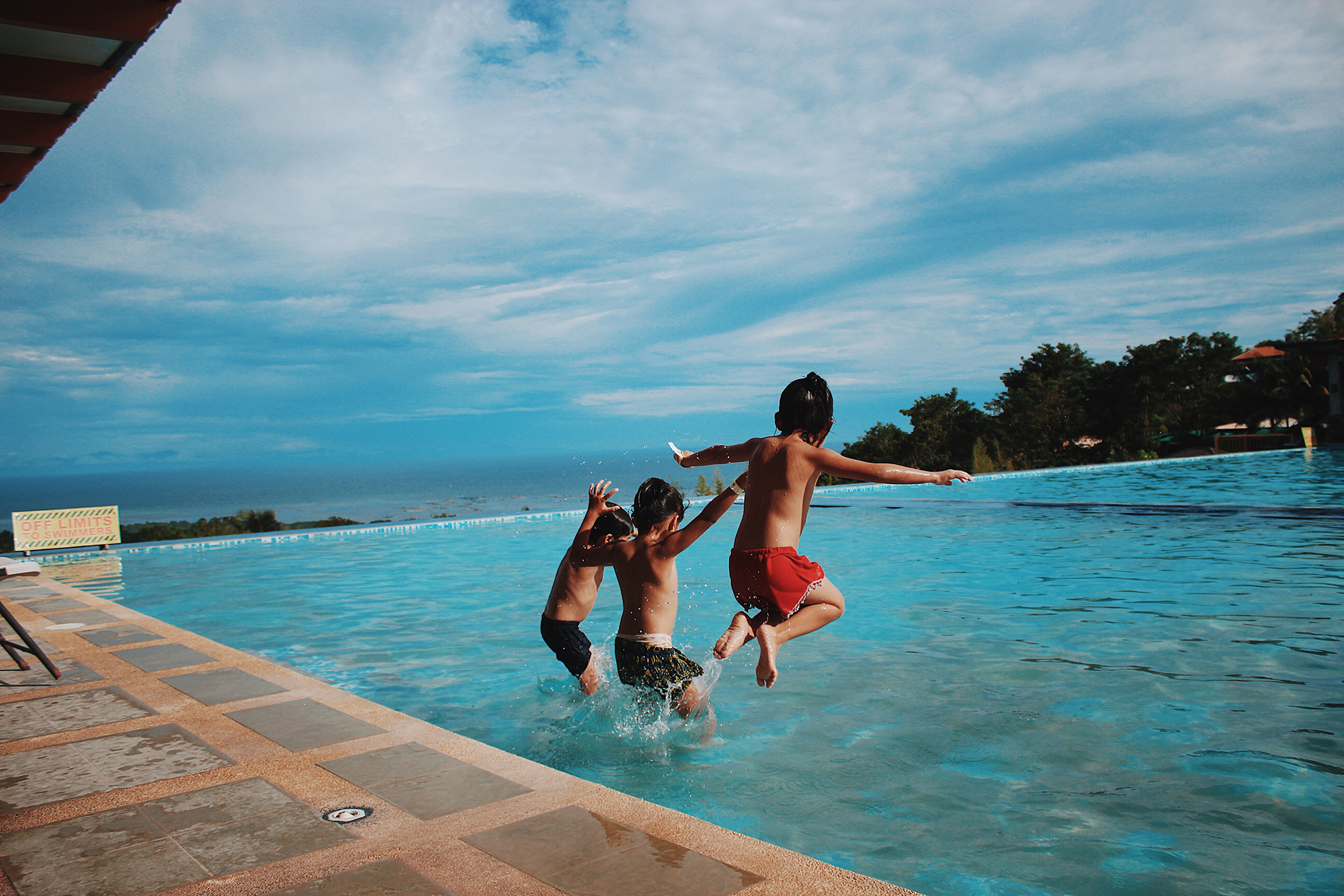 Enfants sautant dans une piscine
